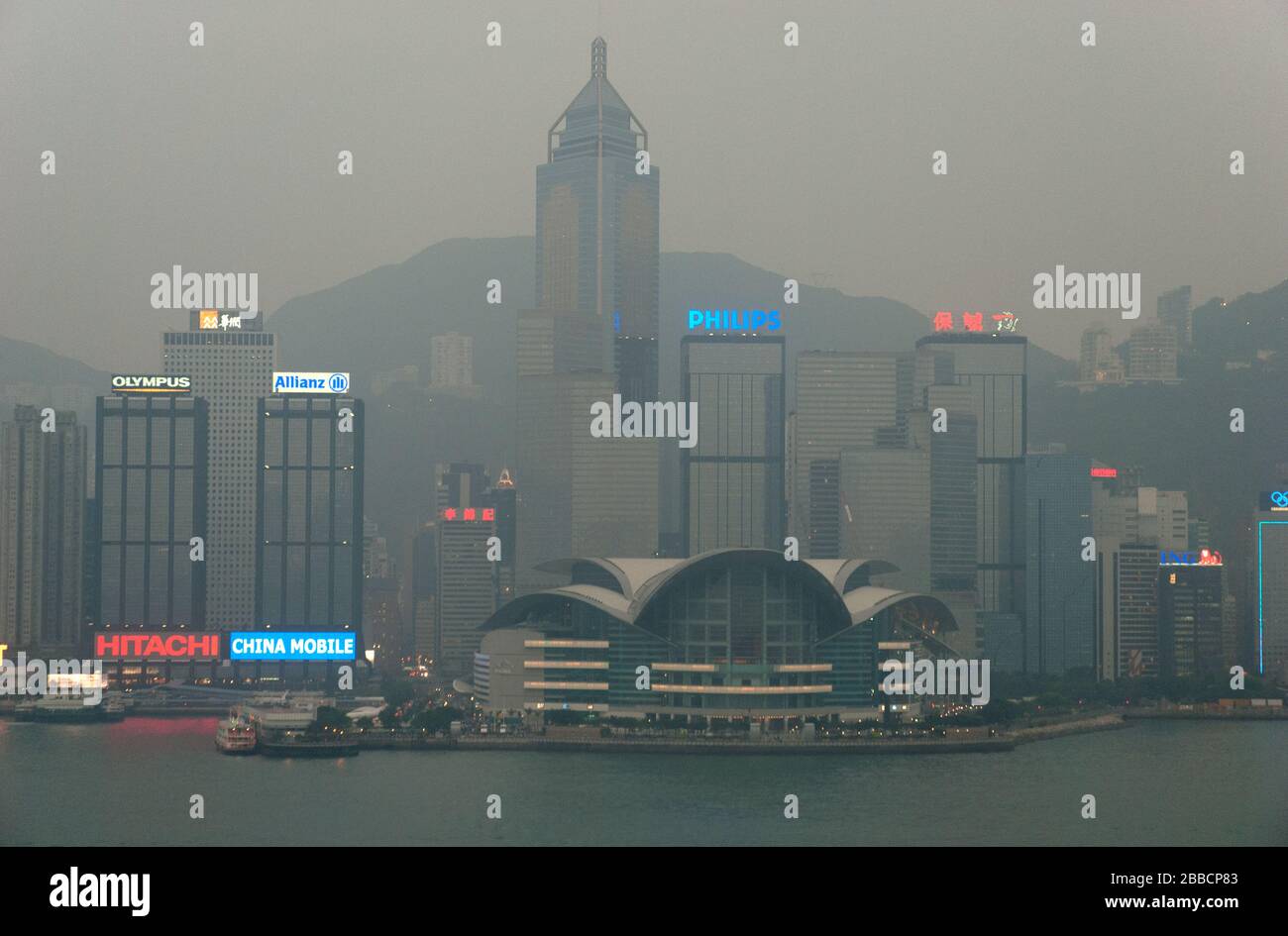 Convention Centre and Victoria harbour in the hazy dusk, Hong Kong Stock Photo