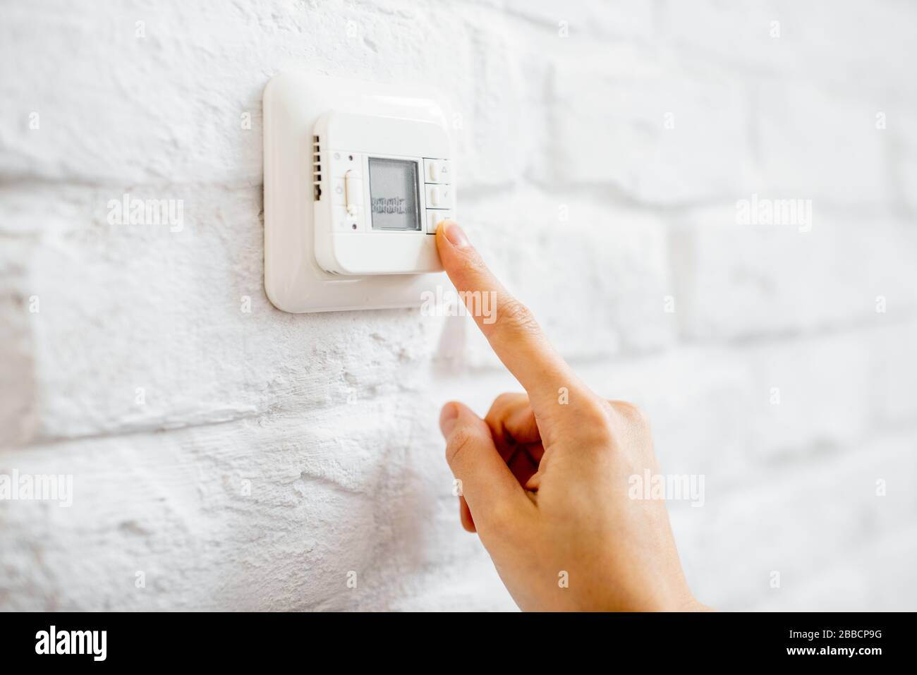 Setting temperature on the control panel of a floor heating, closeup