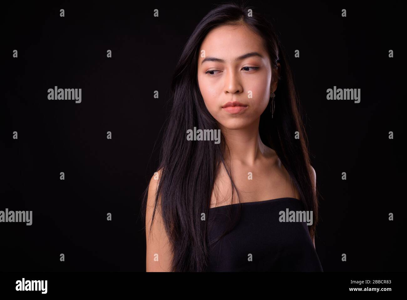 Face of young beautiful Asian woman thinking and looking down Stock ...