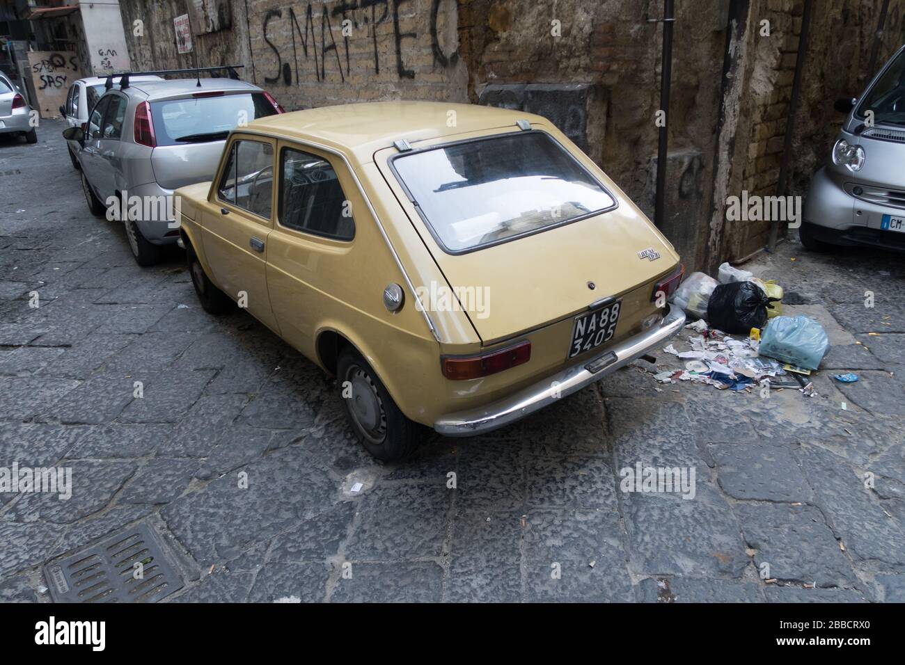 The rear view of an old FIAT 127 car in a street of Naples, Italy. Stock Photo