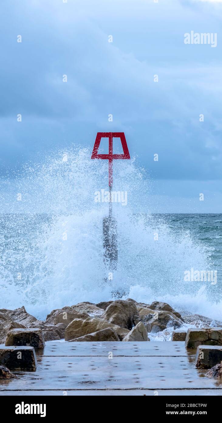 Windy groyne marker post at Bournemouth, Dorset, UK Stock Photo