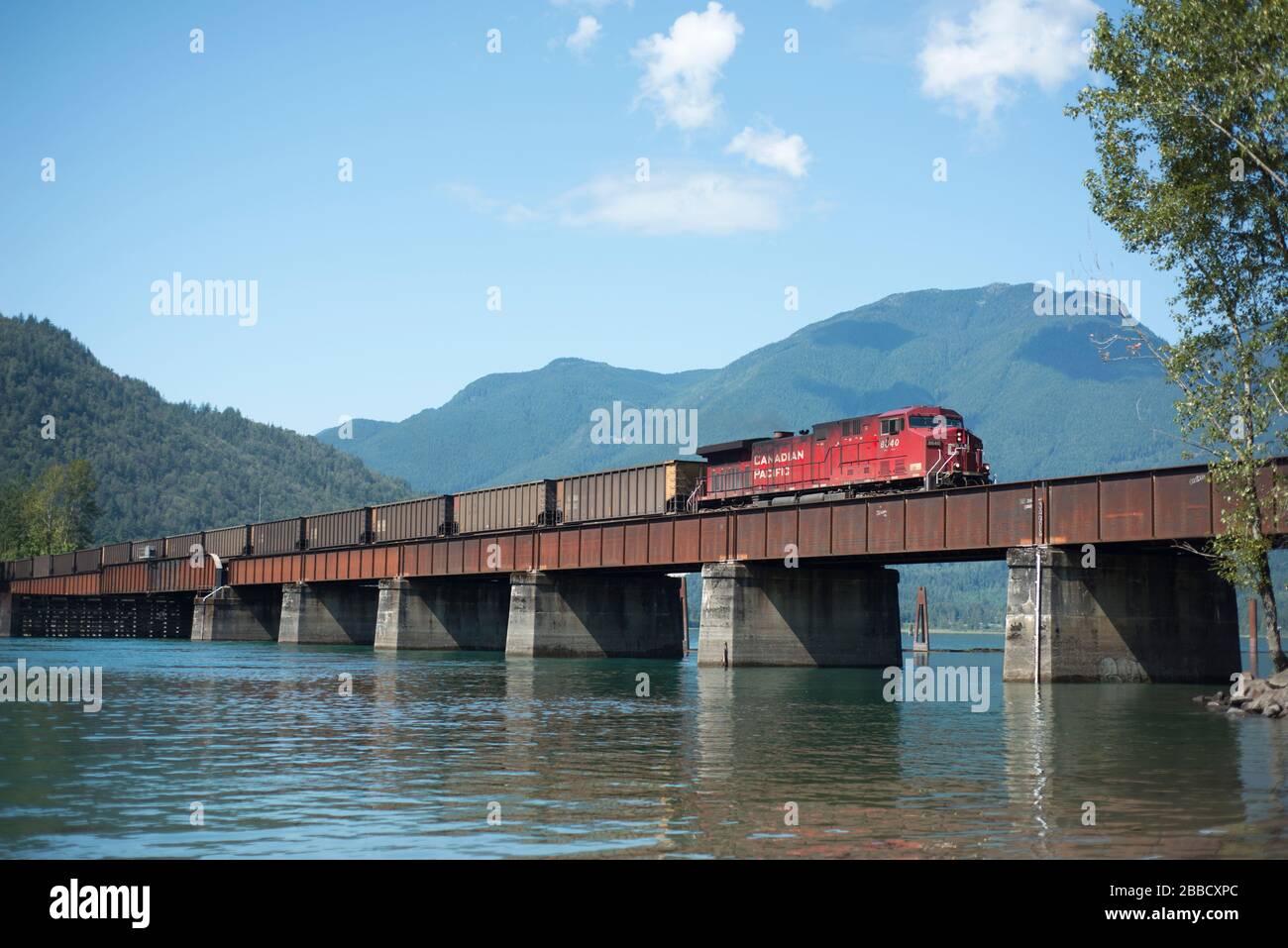 A CP (Canadian Pacific) empty coal train crosses the Harrison River near Harrison Mills, British Columbia, Canada. Stock Photo