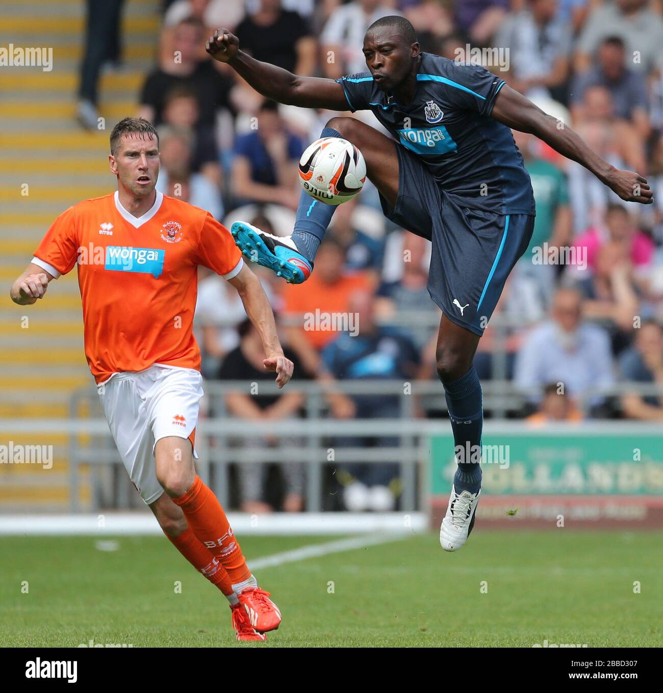 Newcastle United's Shola Ameobi controls the high ball in front of Blackpool defender Kirk Broadfoot Stock Photo
