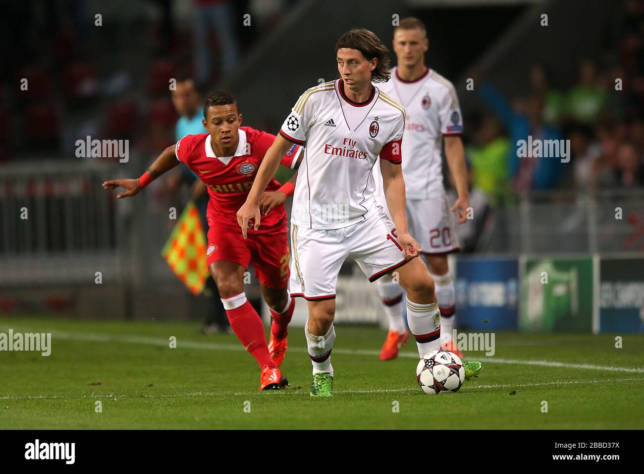 (Left to Right) PSV Eindhoven's Memphis Depay and AC Milan's Riccardo Montolivo battle for the ball. Stock Photo