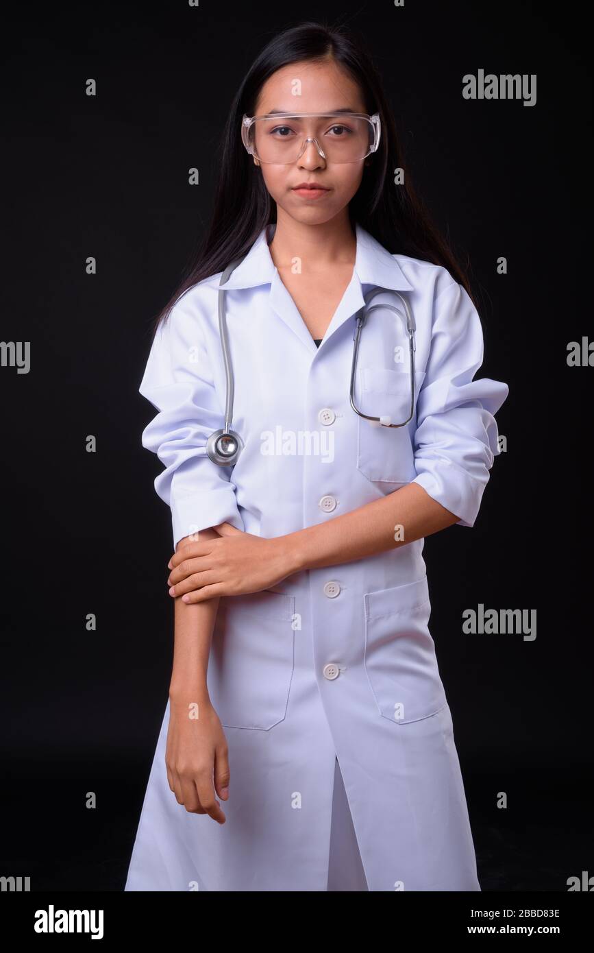 Portrait of young beautiful Asian woman doctor as scientist Stock Photo ...