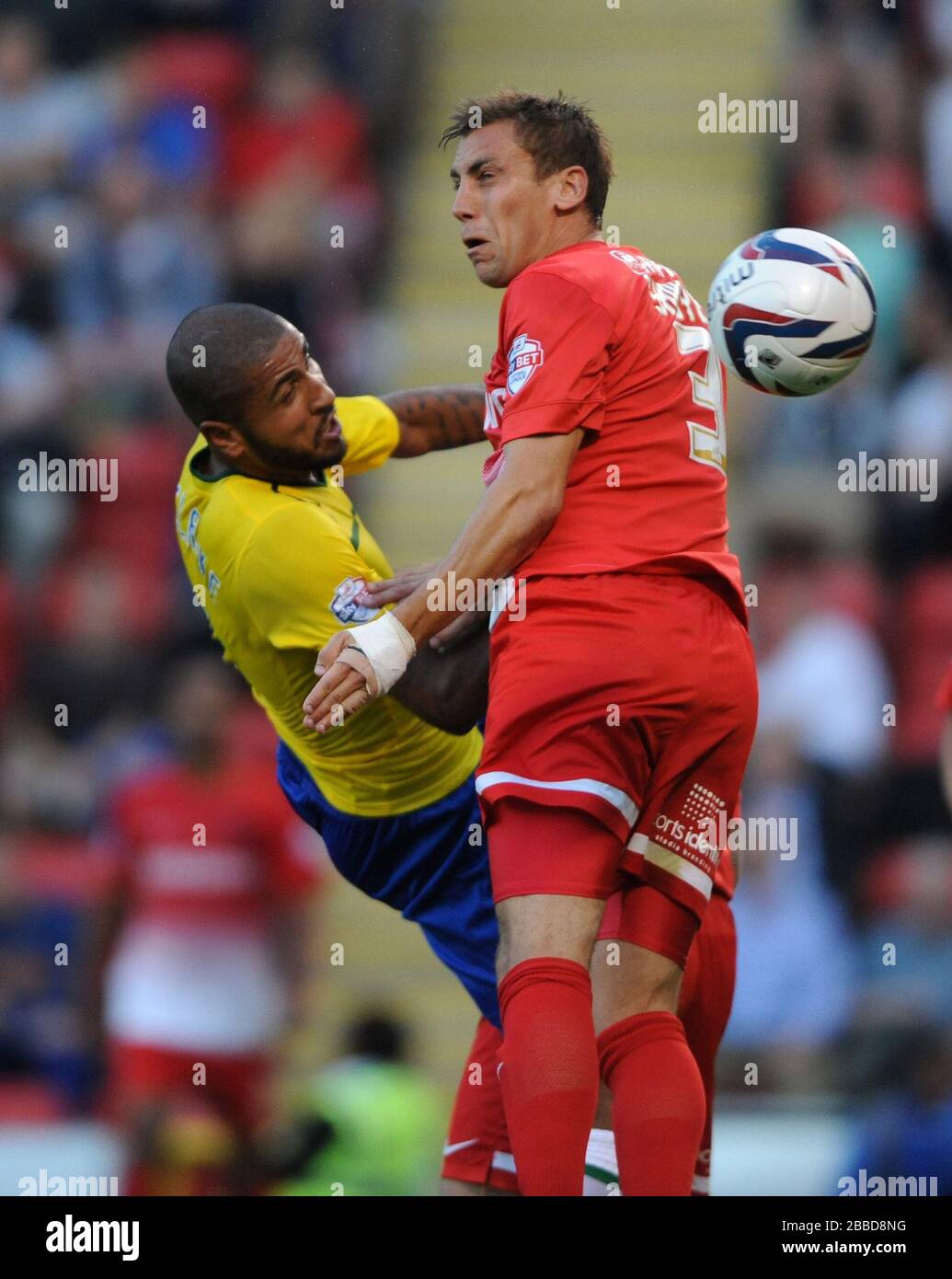 Leyton Orient's Gary Sawyer and Coventry City's Leon Clarke (left) battle for the ball in the air Stock Photo