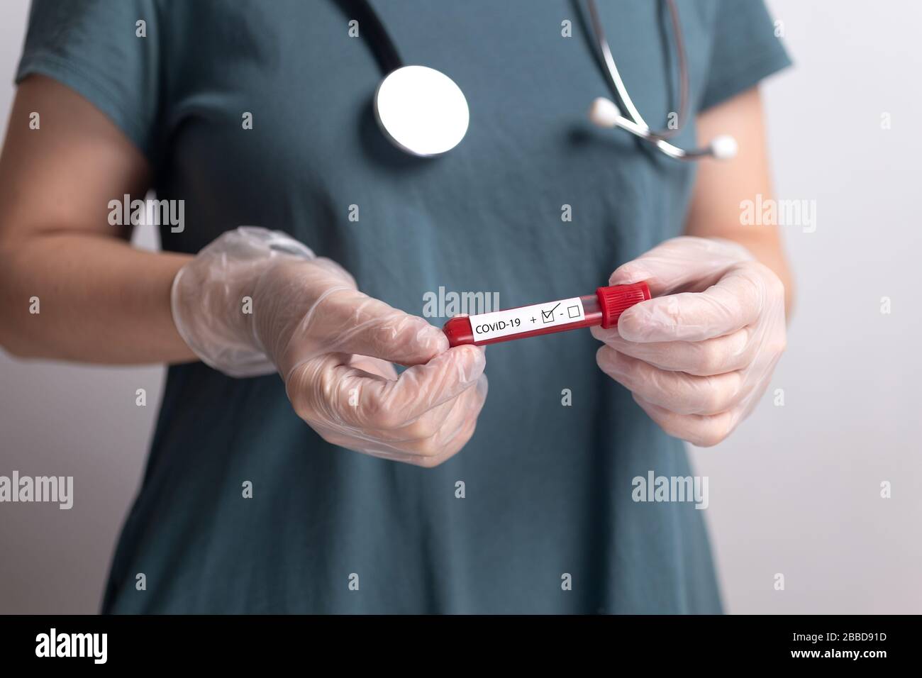 Doctor nurse holding coronavirus test kit blood result Stock Photo