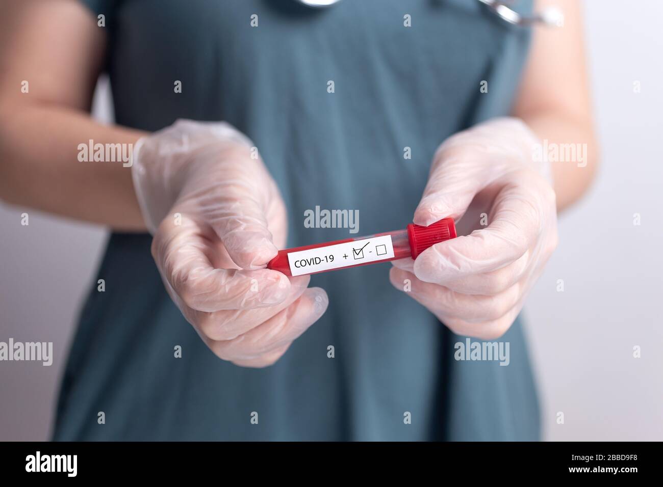 Doctor nurse holding coronavirus test kit blood result Stock Photo