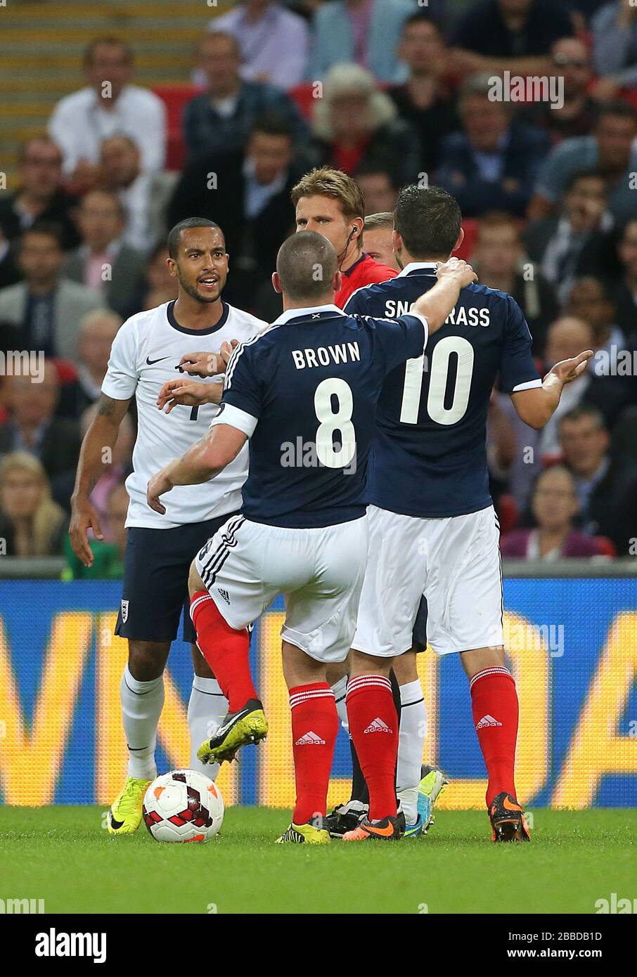 Tempers flare between England's Theo Walcott (left) and Scotland's Robert Snodgrass (right) Stock Photo