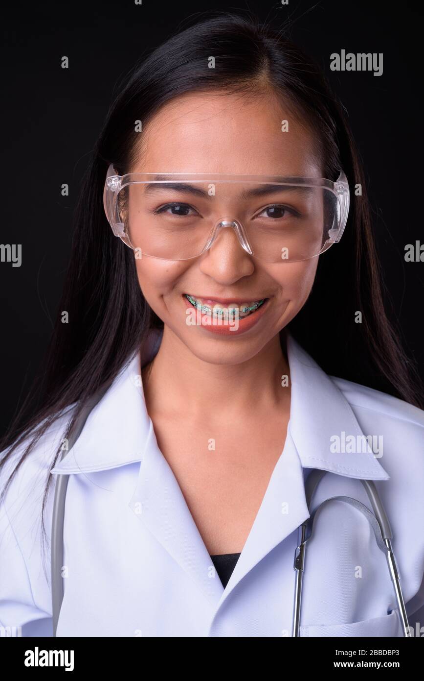 Face of happy young Asian woman doctor as scientist smiling Stock Photo ...