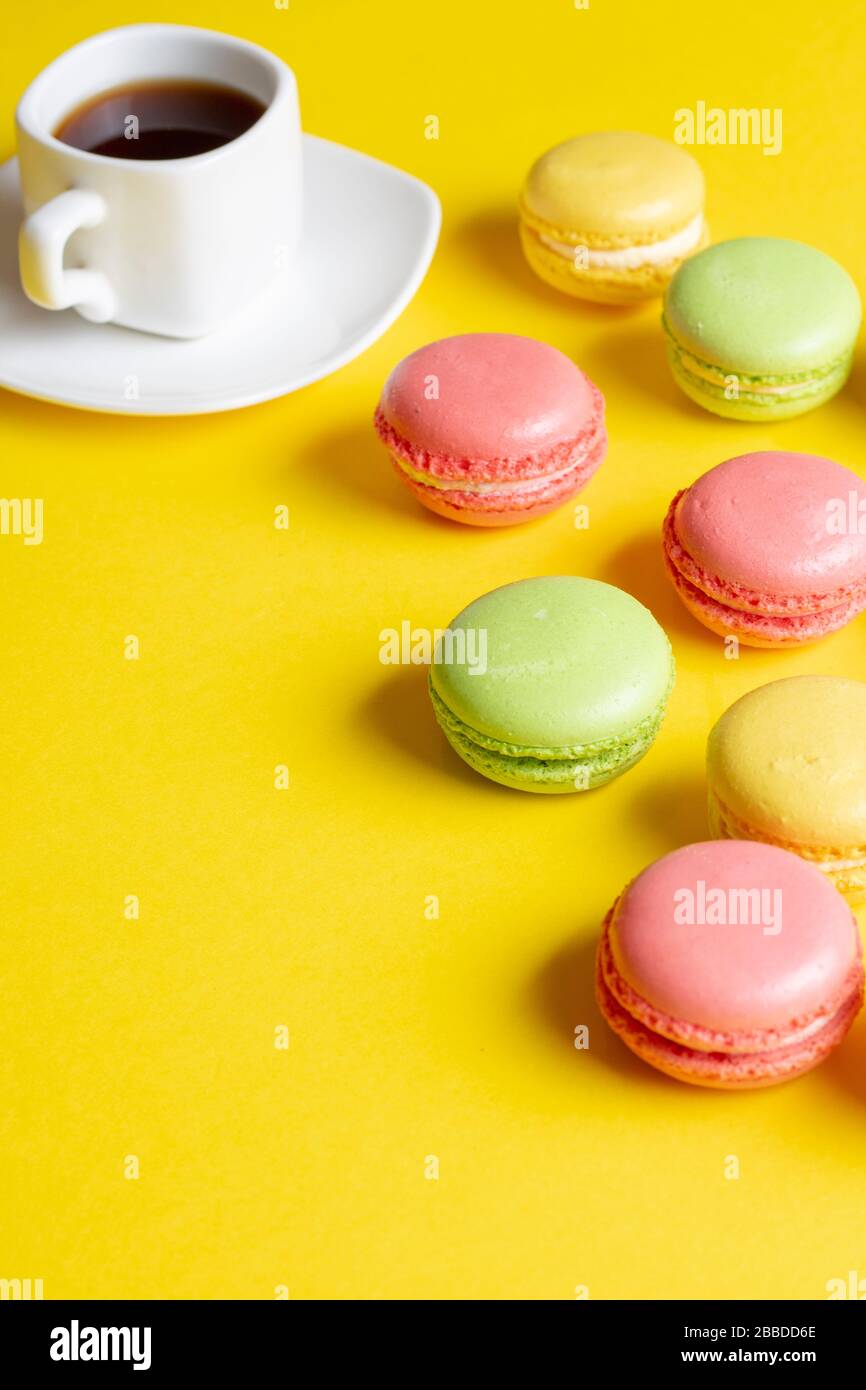 Download Delicious Colorful Pastel Macarons With Black Coffee Cup On Yellow Paper Vertical Image And Place For Text Food Stock Photo Alamy Yellowimages Mockups