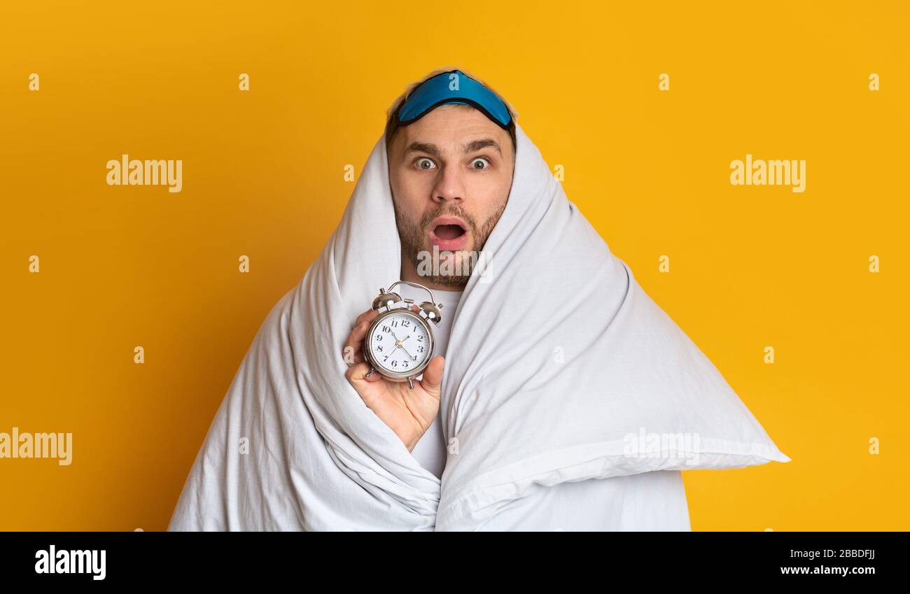 Young man does not want get up for work Stock Photo