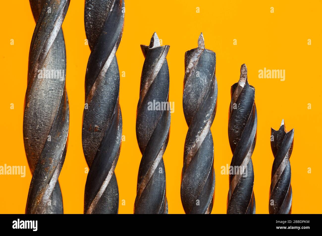 Drills for wood of different sizes for a drill on an orange background