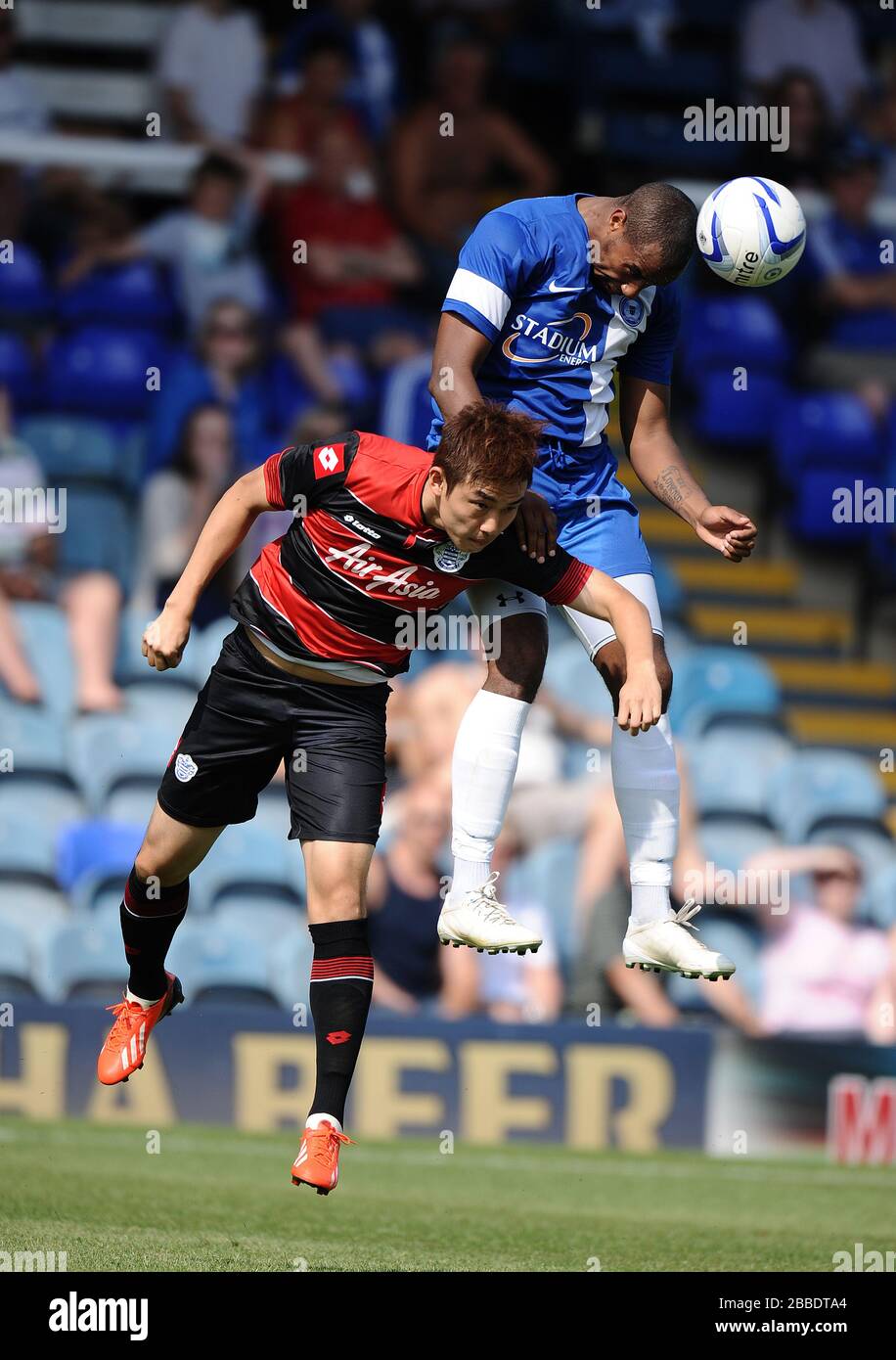 Peterborough United's Tyrone Barnett wins the ball in the air from Queens Park Rangers' Yun-Suk Young Stock Photo