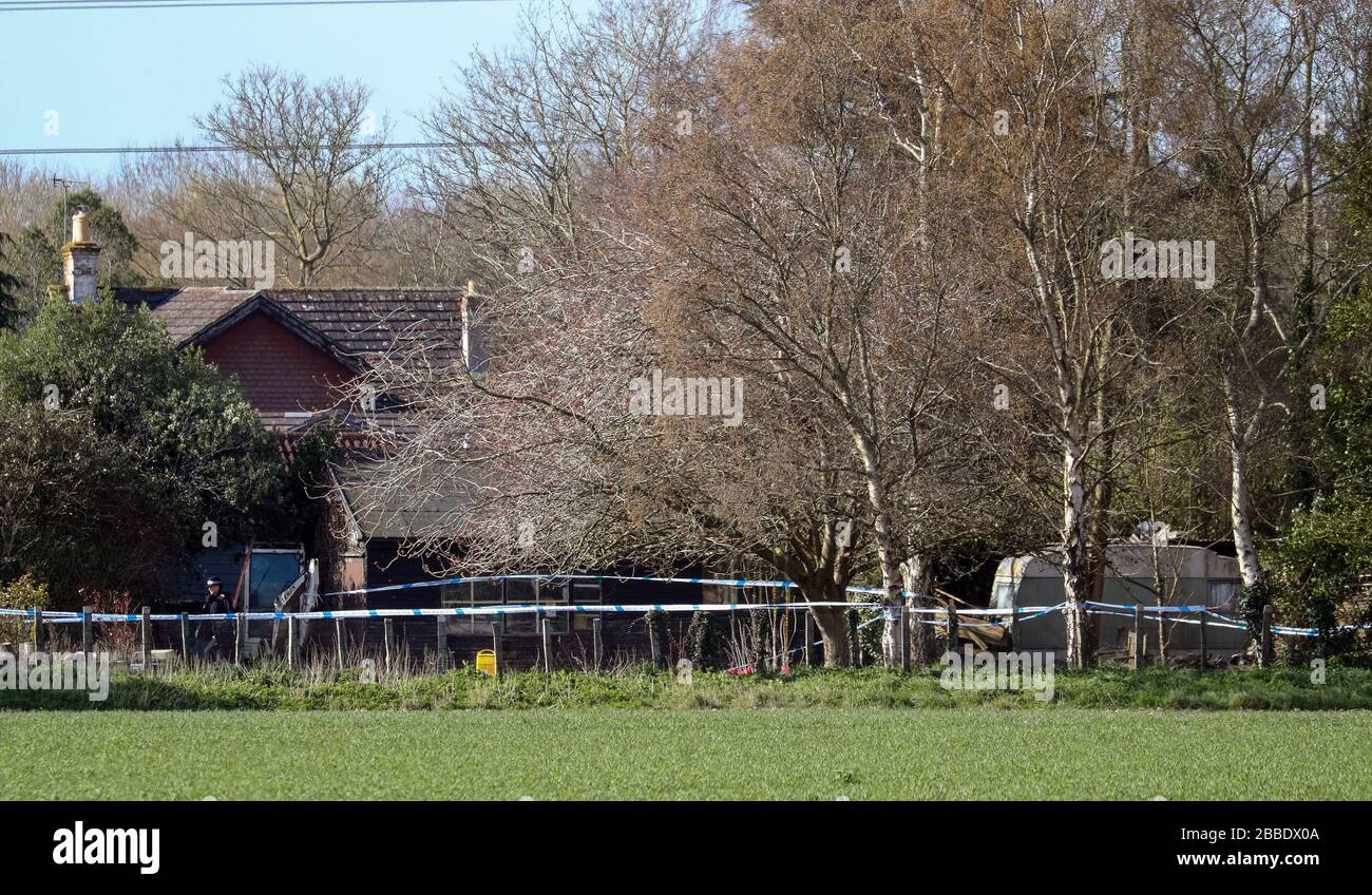 Police tape surrounds a property on Duffield Lane, Woodmancote, West
