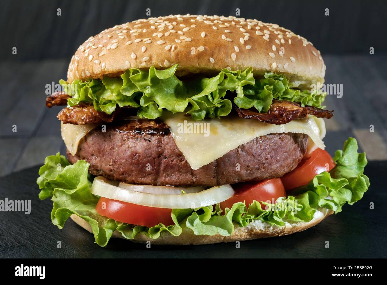 A classic big hamburger with crispy bacon. Stock Photo