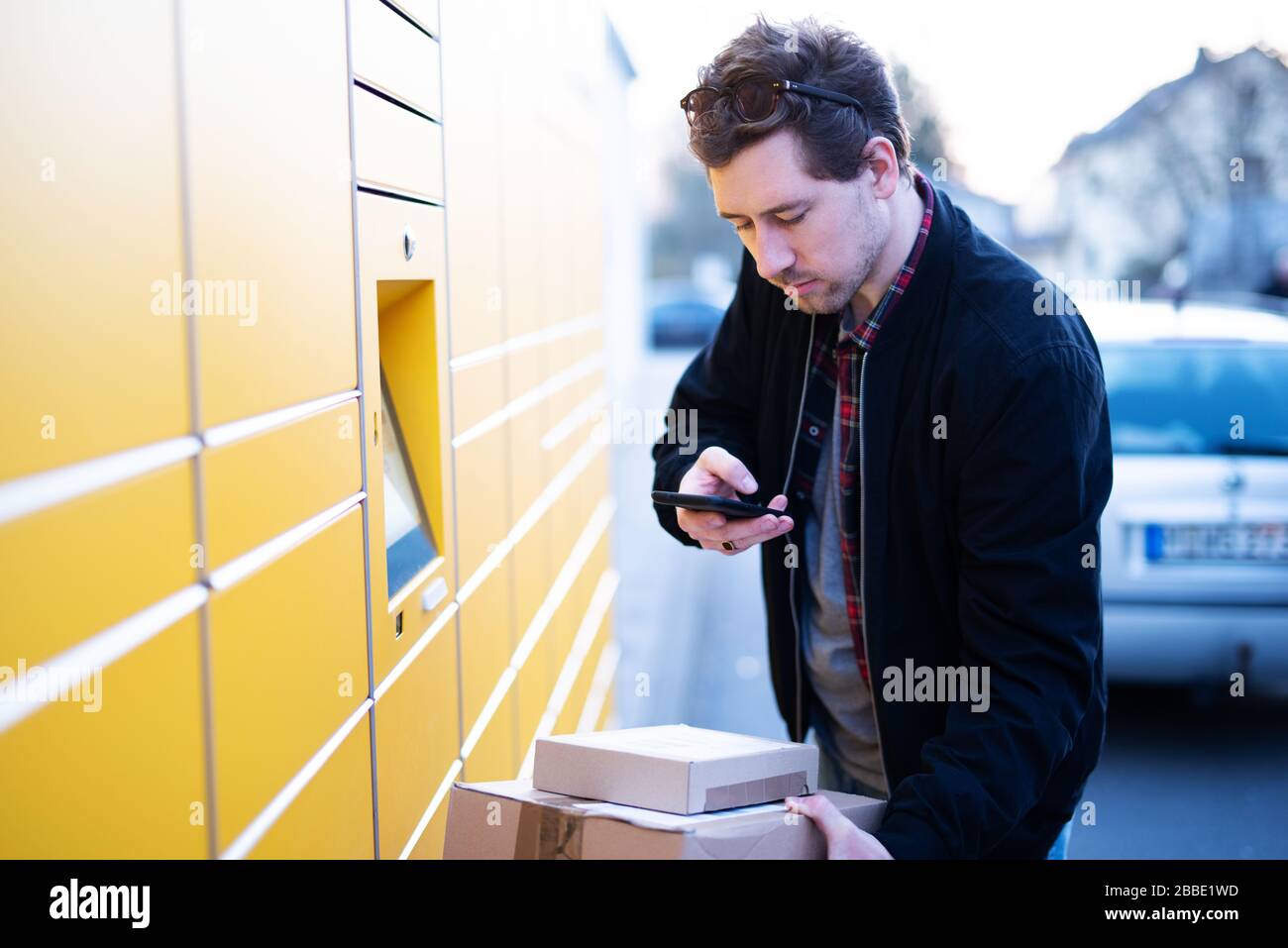 A man brings packages to a packing station or picks them up Stock Photo