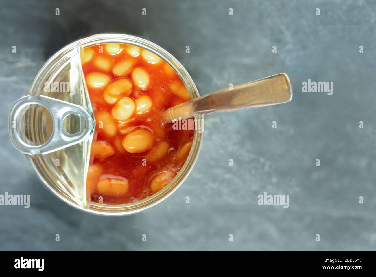 Baked beans in a ring pull can with a spoon Stock Photo