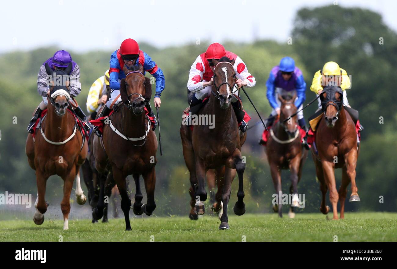 Benoni (red cap, white sleeves) ridden by Dane O'Neill on the way to winning The Alex Moilliett Northern Hammer Handicap from second placed Magical Rose (left) ridden by Neil Callan Stock Photo