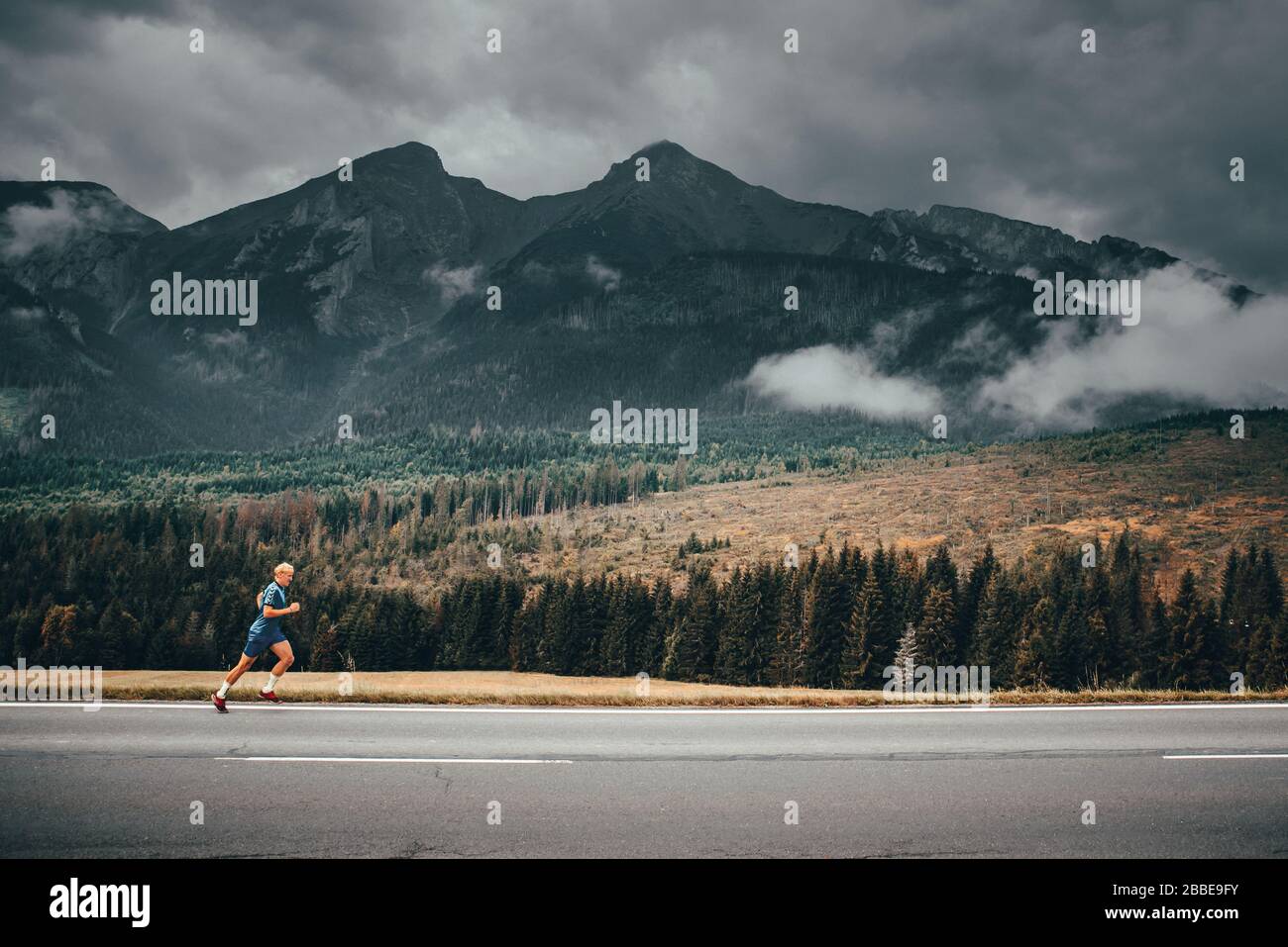 Morning run in autumn mountains landscape. Alps in background. Italy. Stock Photo