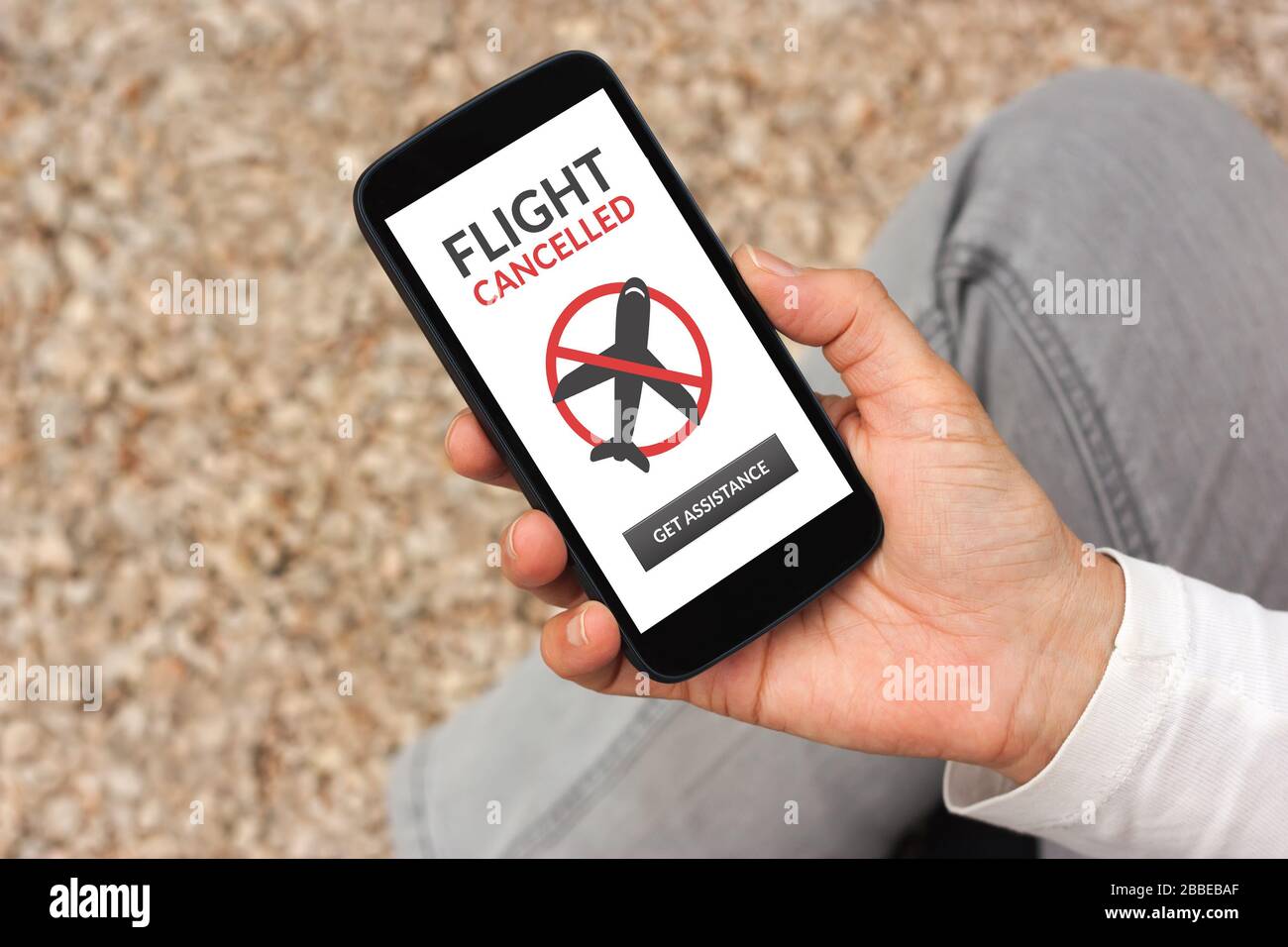Hand holding smart phone with flight cancelled concept on screen Stock Photo