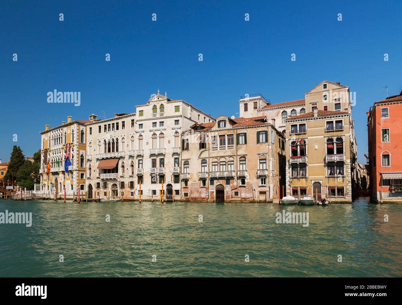 Grand Canal and moored boats in front of Renaissance architectural style palace buildings including the Palazzo Cavalli-Franchetti palace, San Marco, Venice, Veneto, Italy Stock Photo