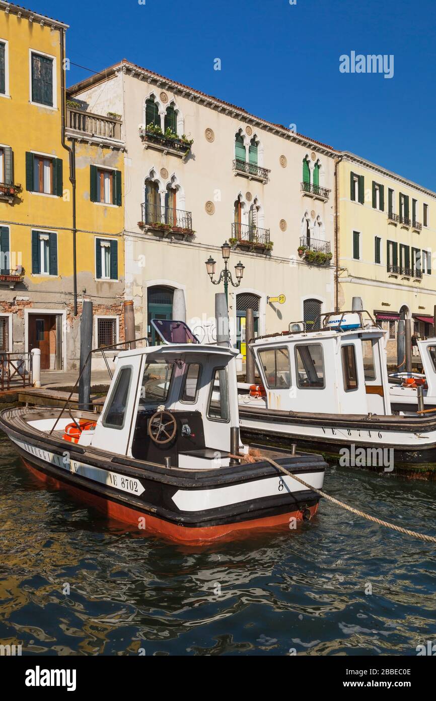 Moored boats and old Renaissance architectural style palaces and residential buildings along the Fondamenta delle Zattere promenade, San Basilio, Dorsoduro district, Venice, Veneto, Italy Stock Photo