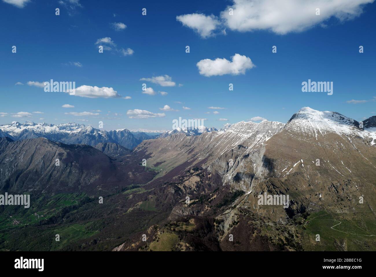 Aerial view of Mount Krn and the Kanin Mountains separating Slovenia from Italy. Julian Alps in the Spring as seen from a paraglider. Stock Photo