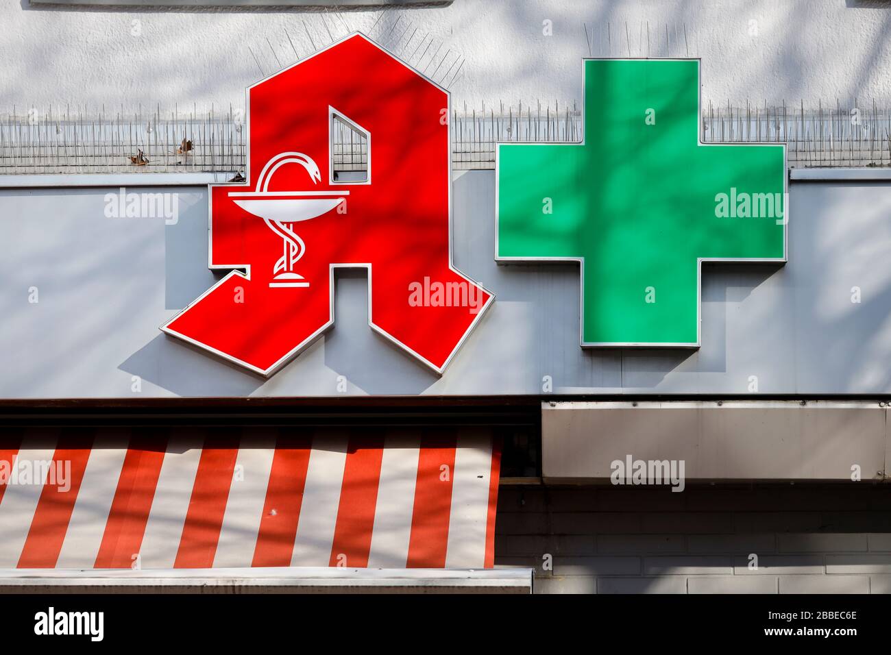 27.03.2020, Essen, Ruhr Area, North Rhine-Westphalia, Germany - Pharmacies are system relevant in the corona crisis, red logo and green cross on the f Stock Photo