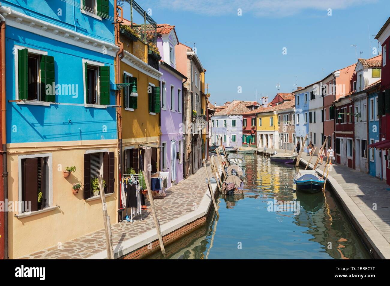 Moored boats on canal lined with colourful houses and shop, Burano Island, Venetian Lagoon, Venice, Veneto, Italy Stock Photo