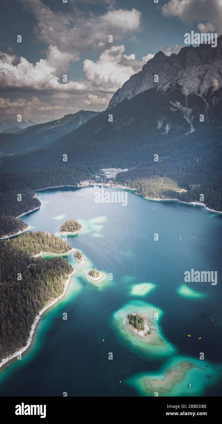 Aerial view shot by a drone of the Eibsee with islands and trees on the lake shore Stock Photo