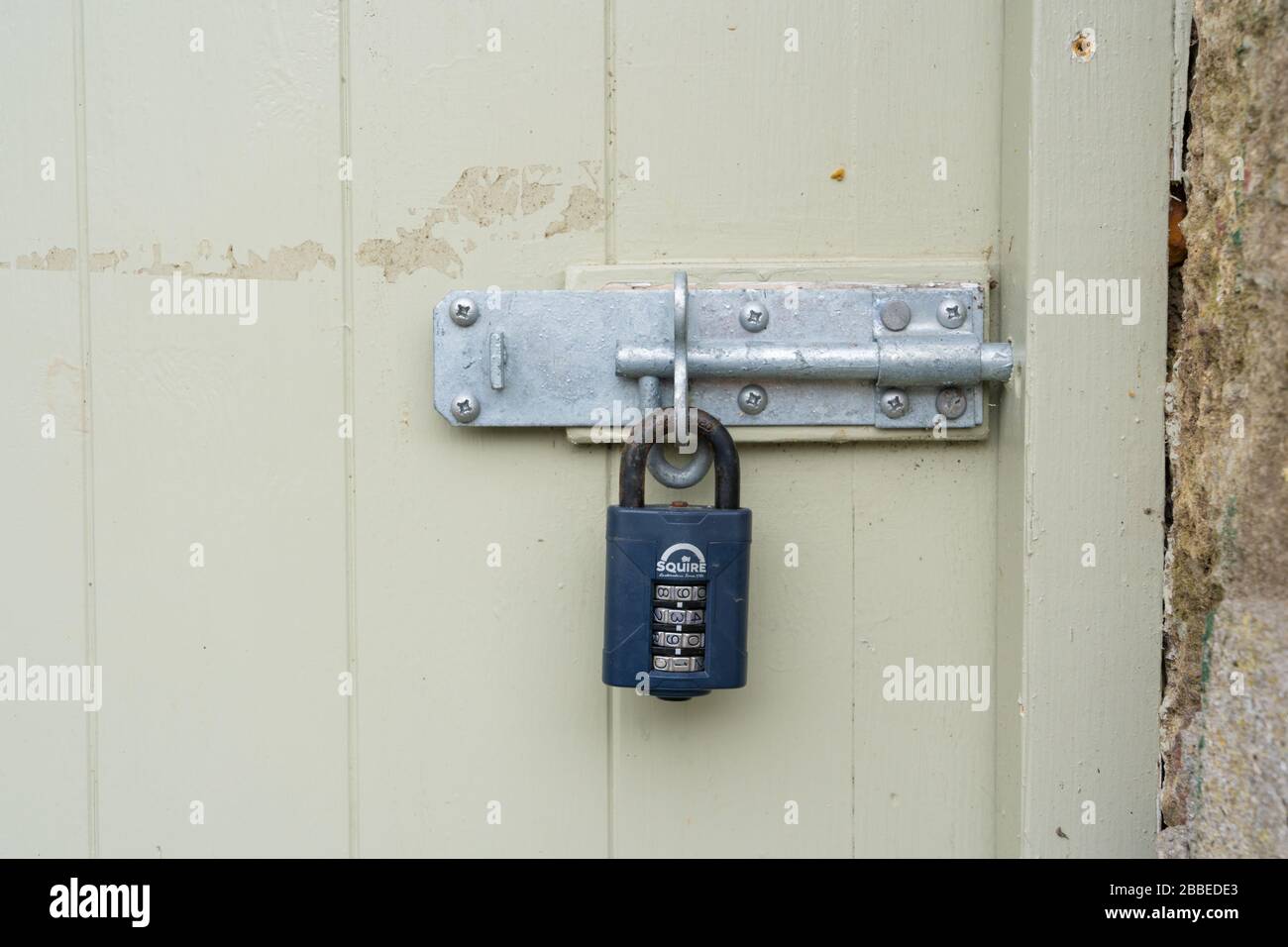 Combination padlock on old door in Newport, Pembrokeshire. Wales. UK Stock Photo