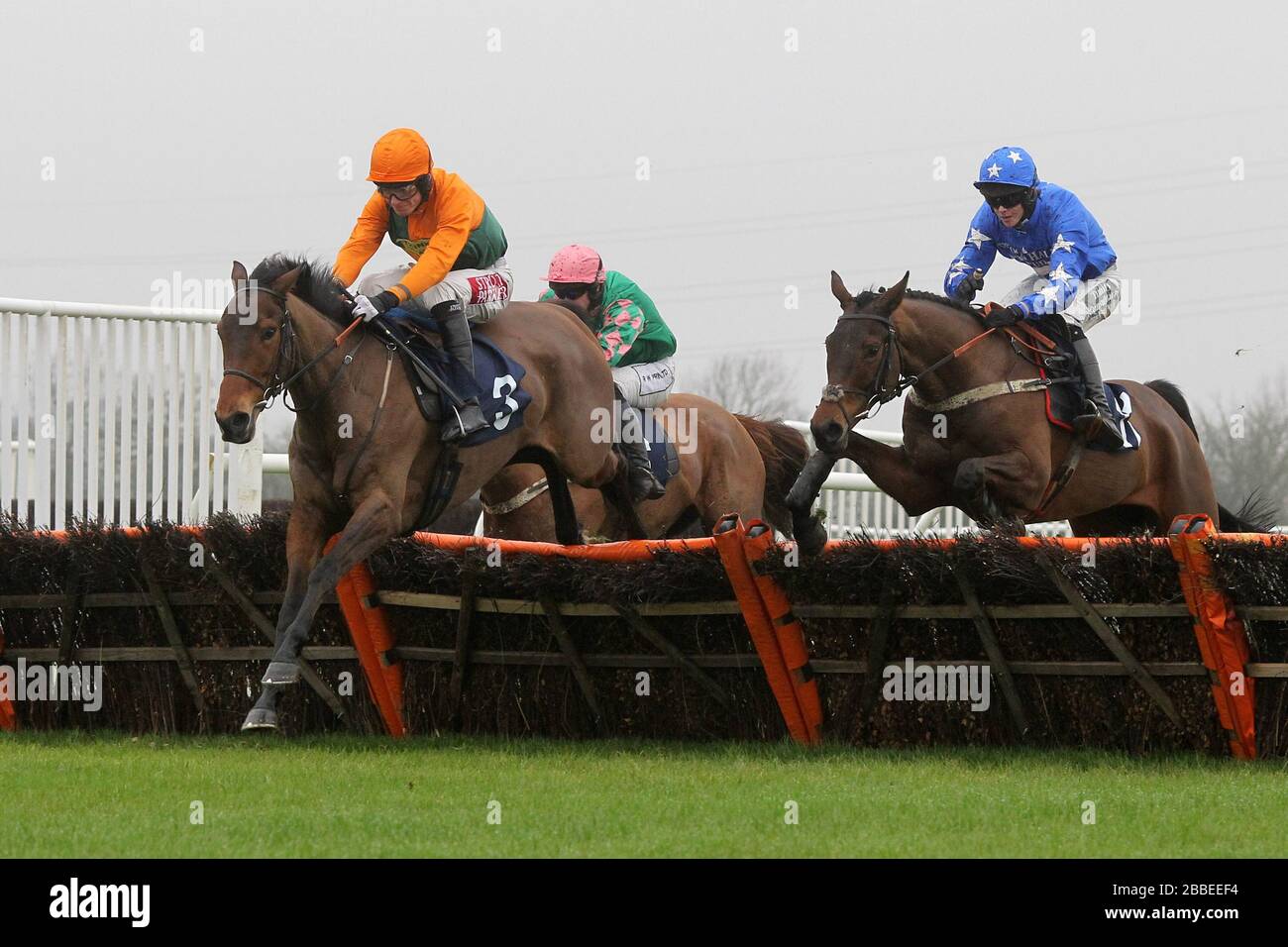 Race winner Winds And Waves ridden by Jake Greenall (3) in jumping action in the Connollys Red Mills Racehorse Cubes Handicap Chase Stock Photo