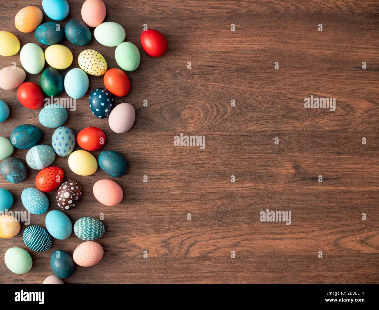 Colorful Easter eggs on wooden table. Easter holiday decorations , Easter concept background. Stock Photo