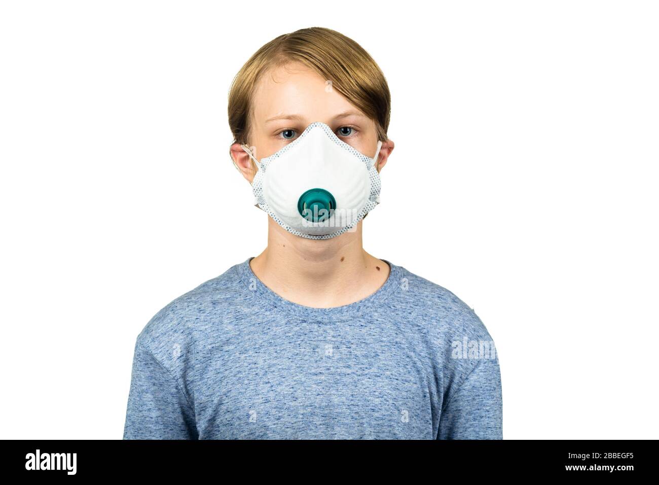 Young teenage boy wearing a protective mask to protect against virus infection.  Isolated on white. Stock Photo