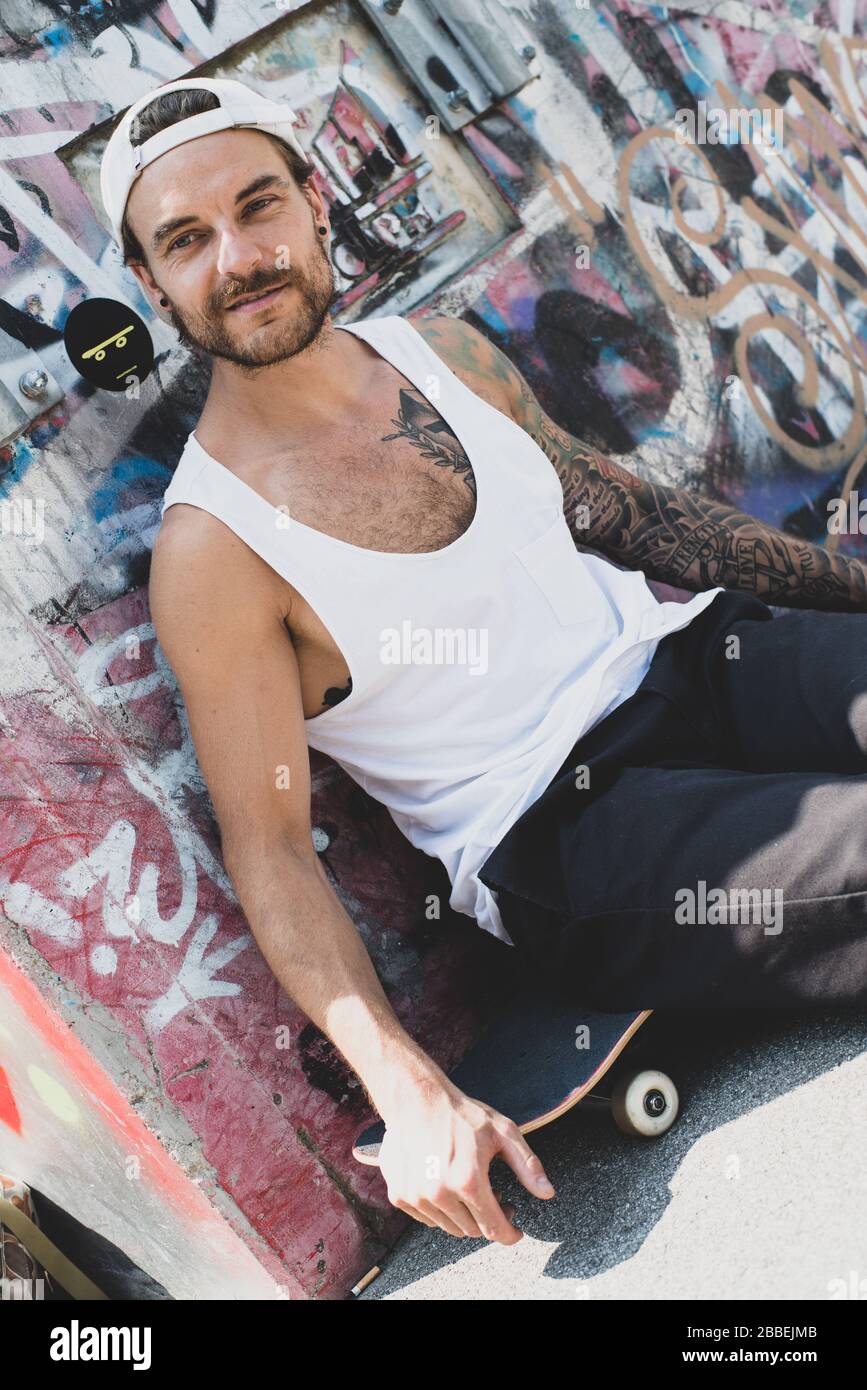 Cool guy with tattoos and baseball cap Stock Photo