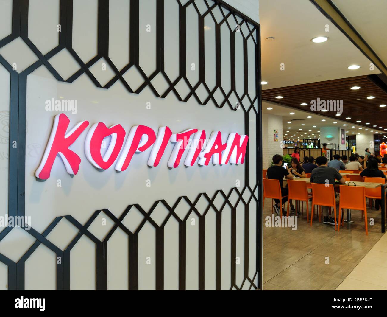 SINGAPORE – 30 DEC 2019 – Exterior of the Kopitiam Food Court at Plaza Singapura shopping mall. Diners are visible in the background. The Kopitiam log Stock Photo