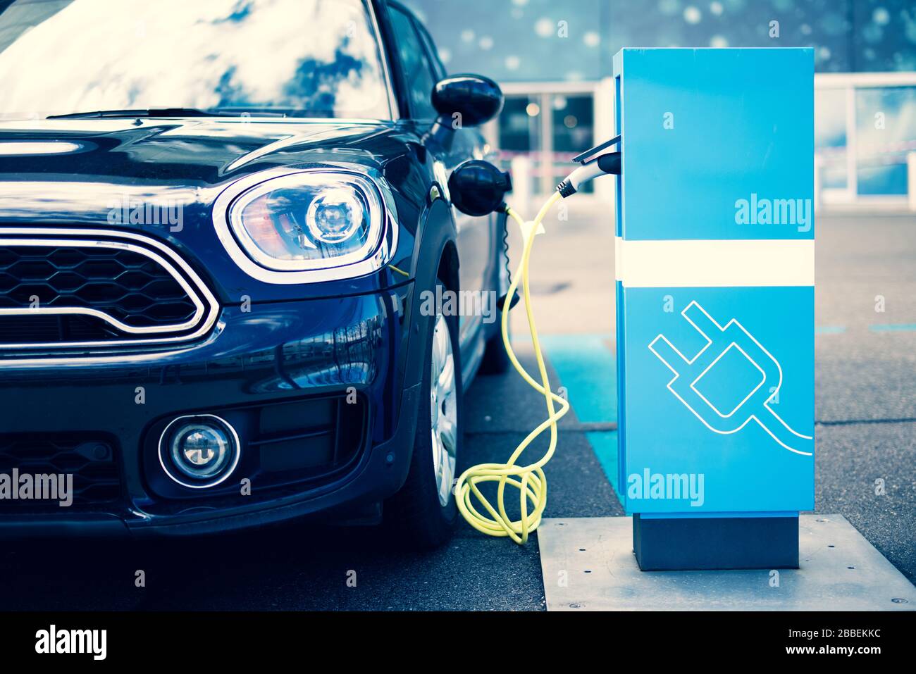 A modern car at a charging station for electric cars Stock Photo