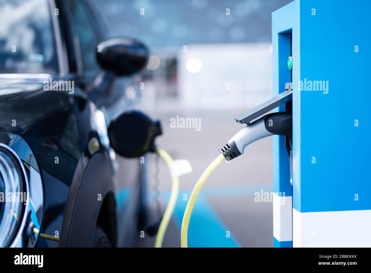 A modern car at a charging station for electric cars Stock Photo