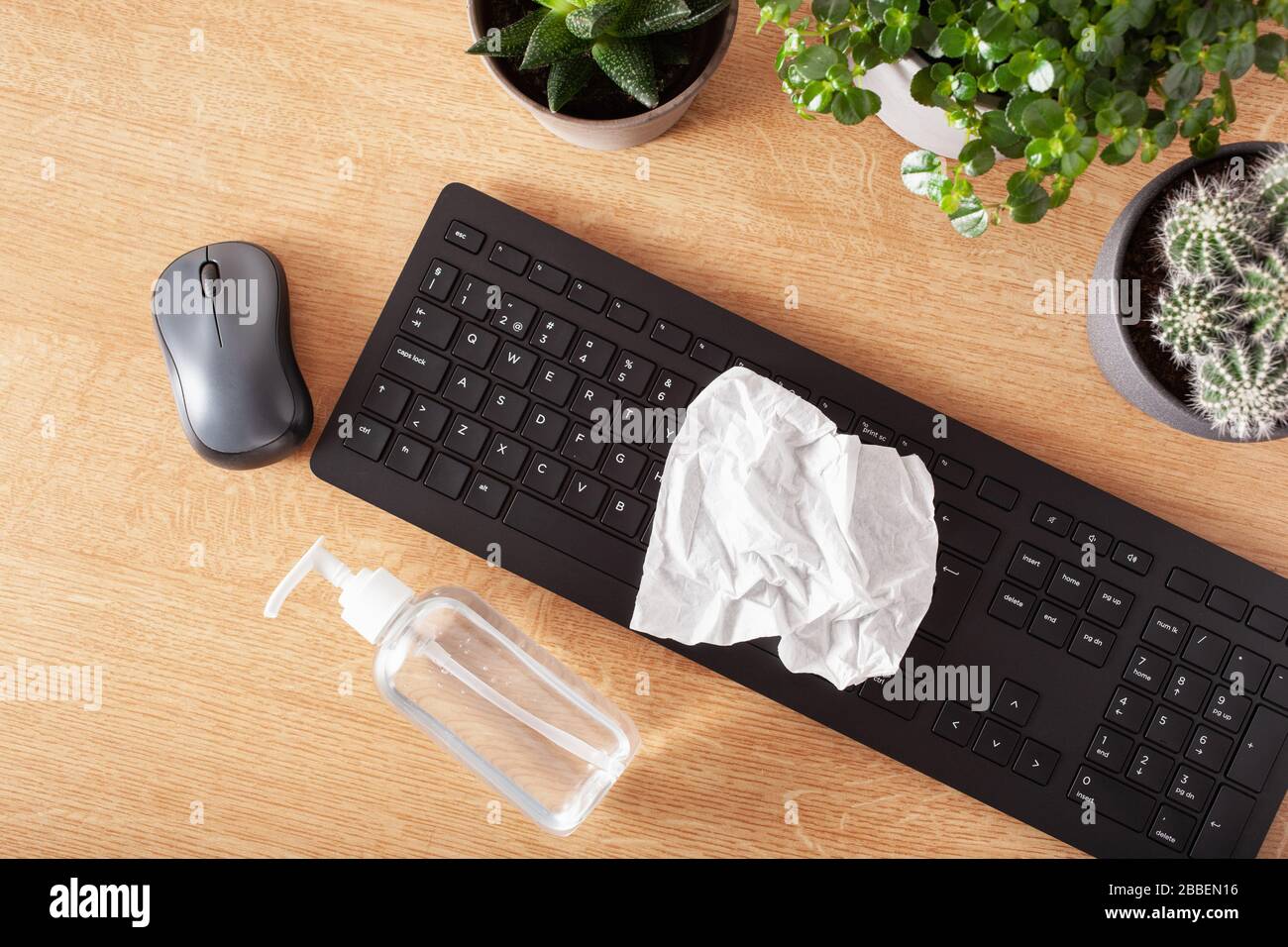 disinfecting wireless keyboard and computer mouse, eliminating germs coronavirus bacteria Stock