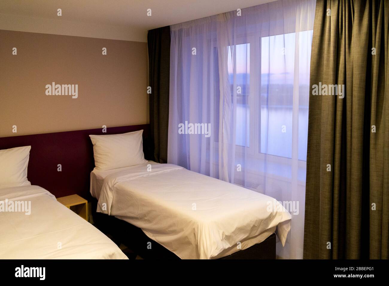 Hotel room with two double beds with pillows Stock Photo