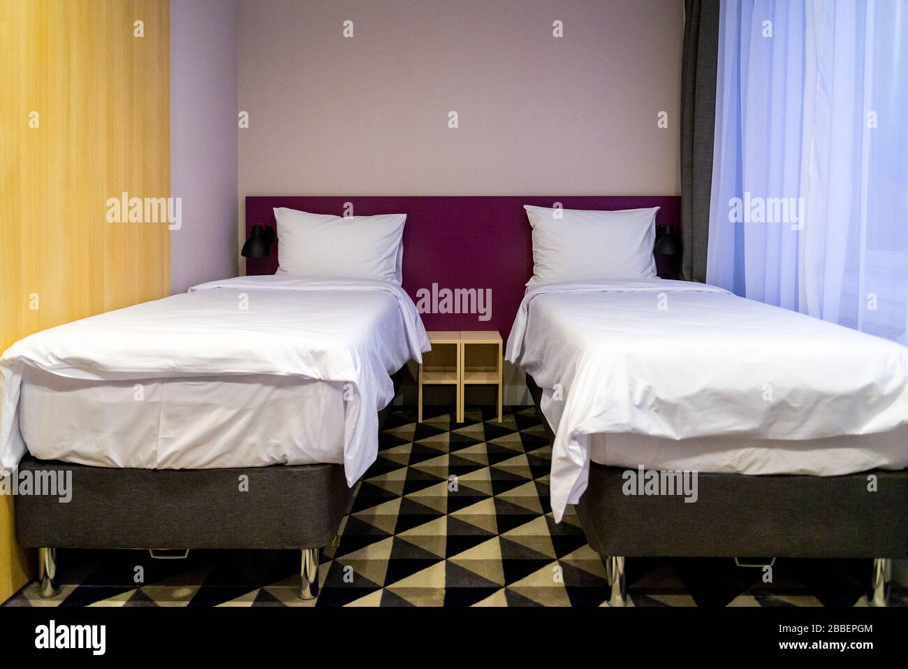 Hotel room with two double beds with pillows Stock Photo