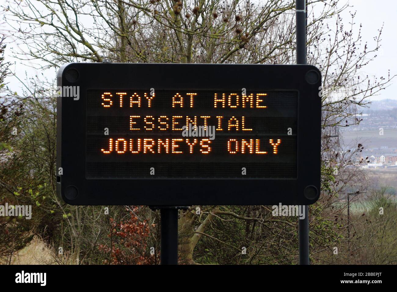 an electronic variable message  traffic sign showing coronavirus travel information. Stock Photo