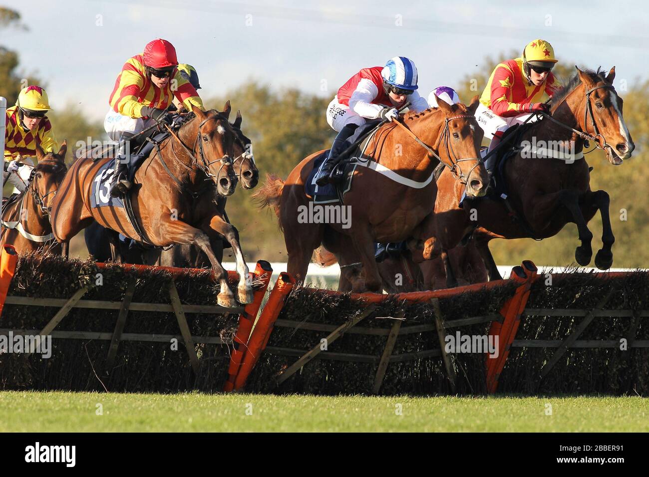 Well Mett ridden by Timmy Murphy (L), Dancing Dude ridden by Andrew Tinkler (C) and Call At Midnight ridden by Mark Marris jump during the Ingrebourne Stock Photo