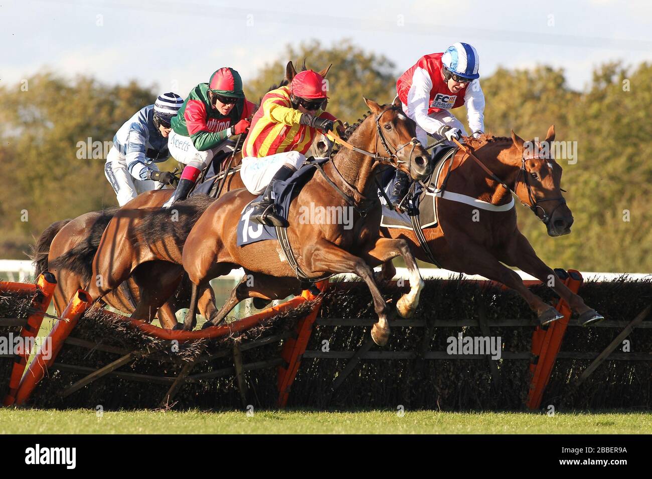 Race winner Genstone Trail ridden by Robert Thornton jumps behind Well Mett ridden by Timmy Murphy and Dancing Dude ridden by Andrew Tinkler (R) durin Stock Photo