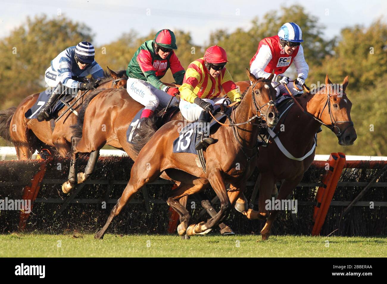 Race winner Genstone Trail ridden by Robert Thornton jumps behind Well Mett ridden by Timmy Murphy and Dancing Dude ridden by Andrew Tinkler (R) durin Stock Photo