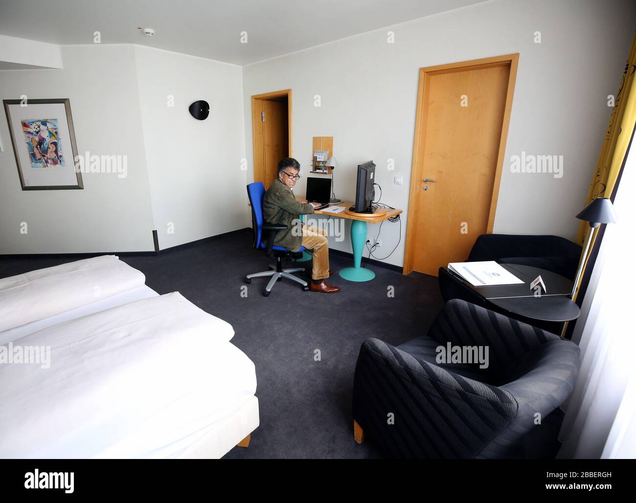 31 March 2020, North Rhine-Westphalia, Mülheim: Moncef Mahmoudi, director  of the Best Western Hotel Mülheim, shows a hotel room for people who have  the ceiling falling on their heads when working at