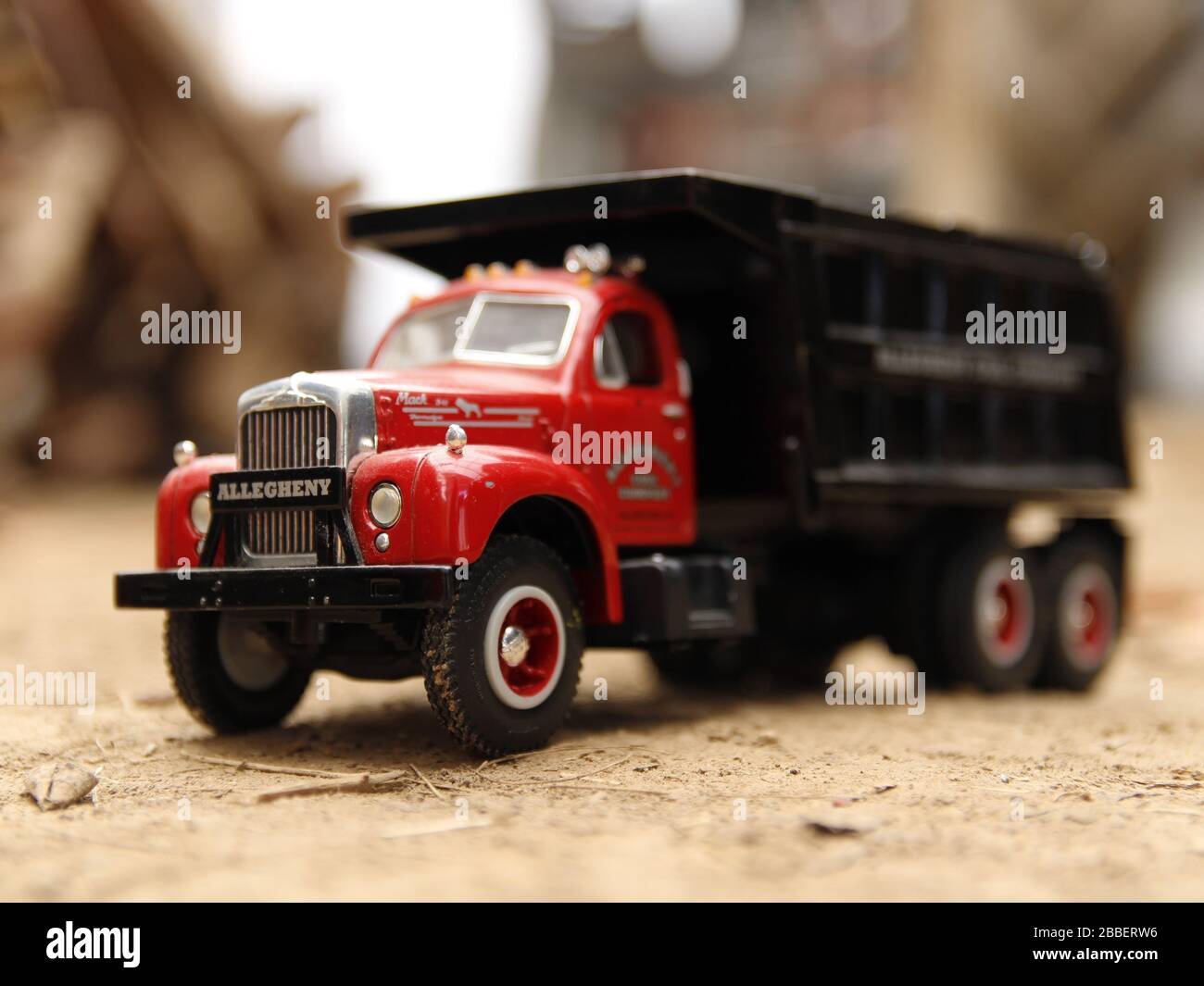 Toy dump truck in the dirt from the front Stock Photo