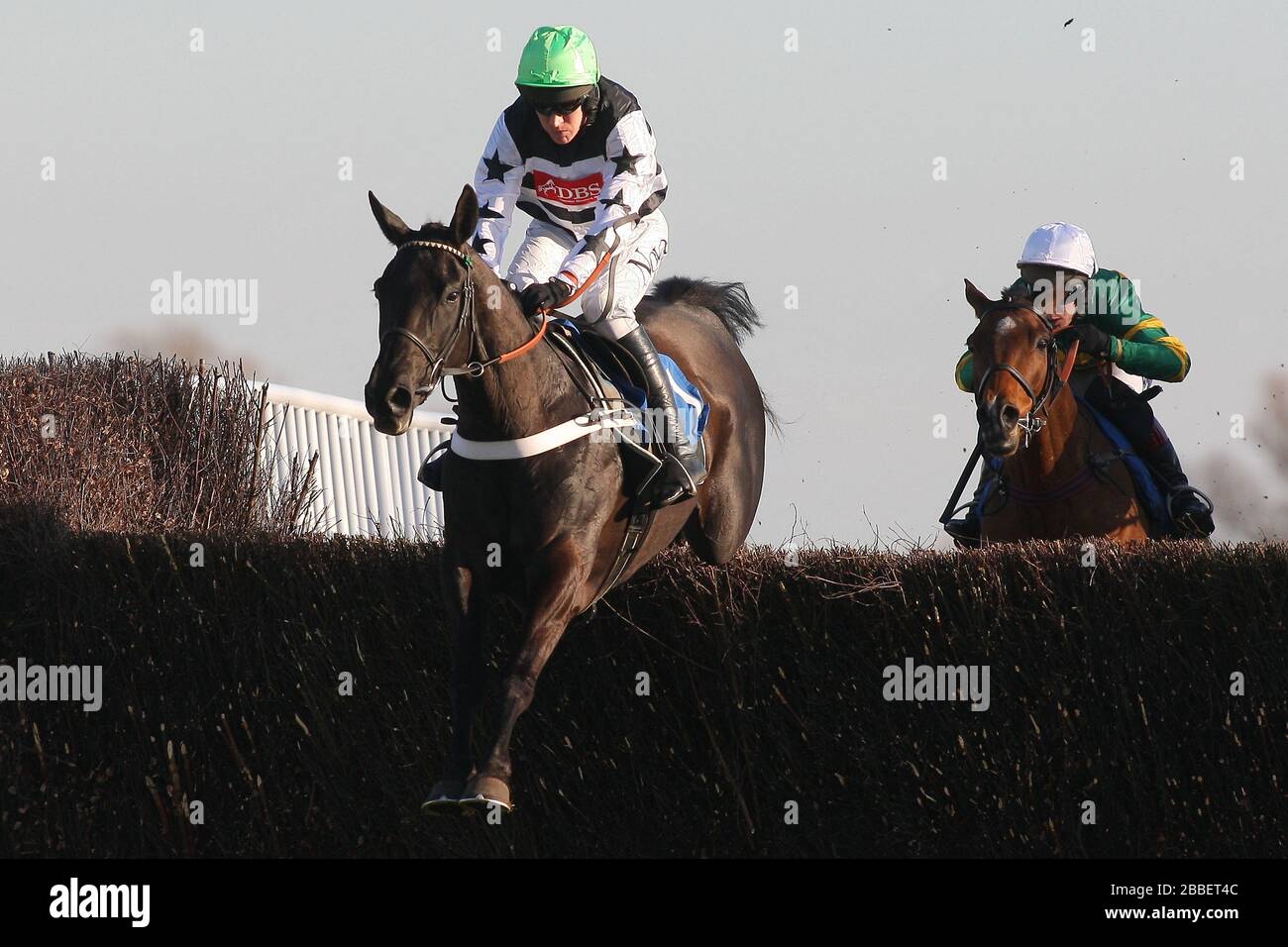 Race winner Owen Glendower ridden by Barry Geraghty in jumping action during the Weatherbys Cheltenham Festival Betting Guide Novices Chase Stock Photo