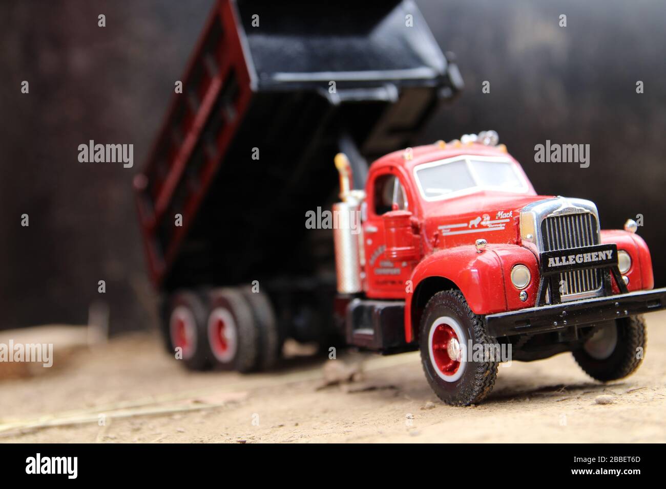 Toy dump truck in the dirt with bed raised Stock Photo